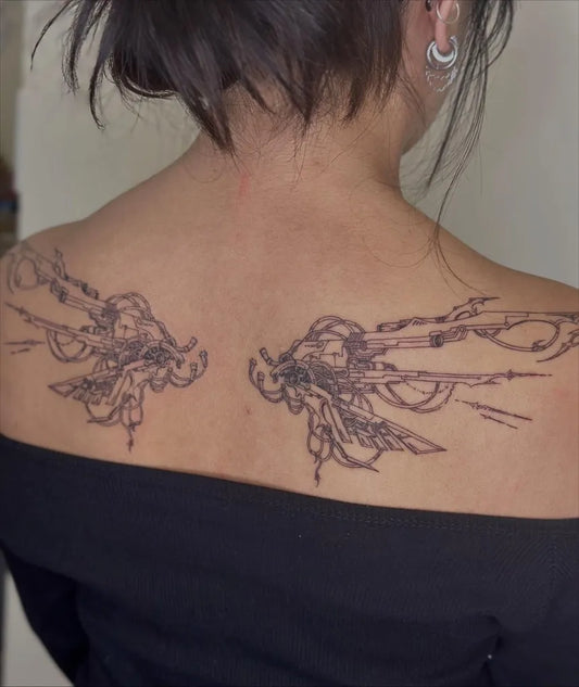 Big Intricate Wings on Women Back Tattoo by @buffbabei.nk