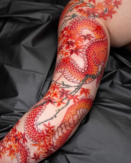 Big Japanese Dragon and Maple Leaves on Women Arm Tattoo by @tattoosfolder