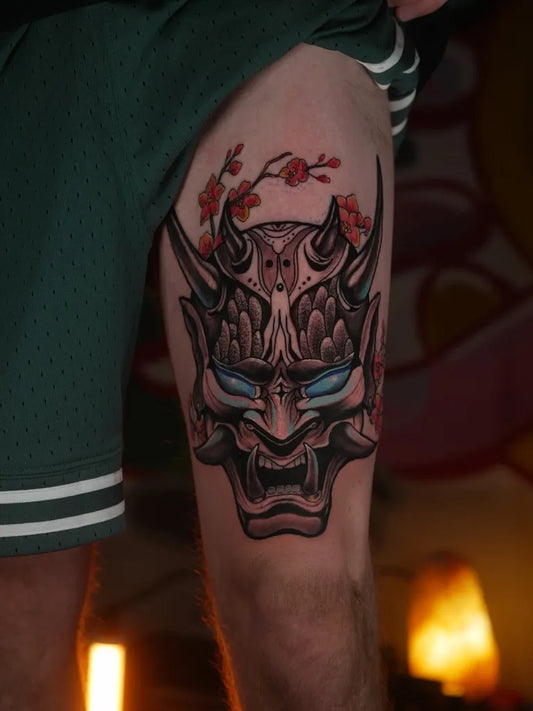 Big Japanese Oni Mask with Cherry Blossoms on Men Thigh Tattoo by @tattoo.studio.sage