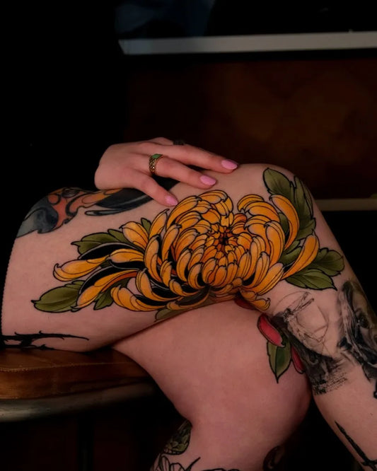 Big Japanese Yellow Chrysanthemum and Leaves Tattoo on Women Thigh by @tattoosbyadamv