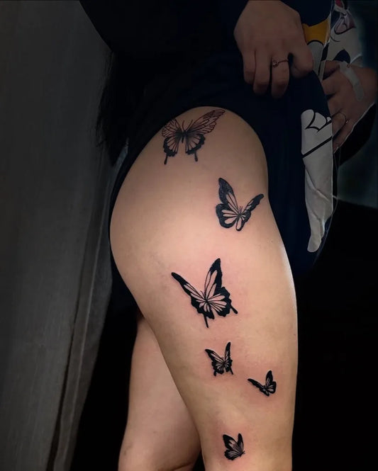 Minimalist Butterflies on Women Thigh Tattoo by @splash.ink.tattoo