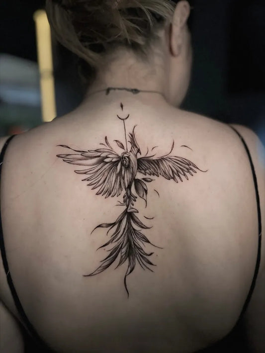 Big Minimalist Phoenix Flowers on Women Back Tattoo by @sehatattoos