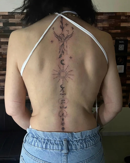 Big Minimalist Phoenix Sun Moon on Women Spine Tattoo by @dancal_tattoo_dxb