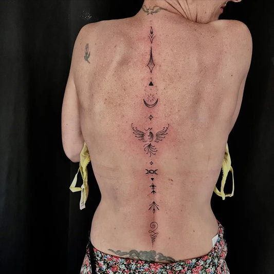 Big Minimalist Phoenix and Geometric Symbols on Women Spine Tattoo by @tomnavtattoo