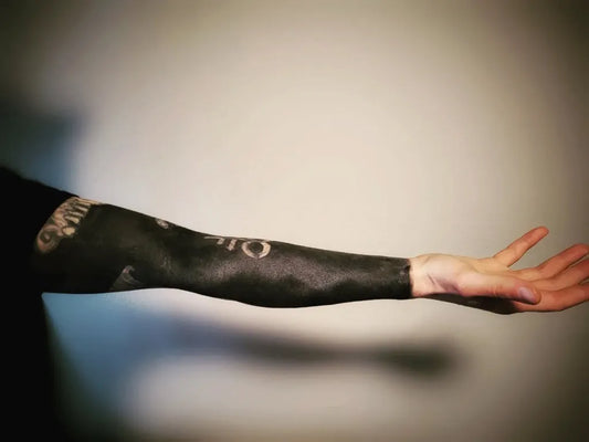 Big Negative Space Black Lace Sleeve Tattoo on Men Arm by @earthling_tattoo