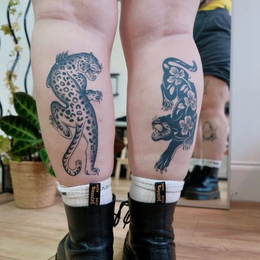Big Negative Space Jaguar and Hibiscus Tattoo on Women Legs by @oneskinnyleg