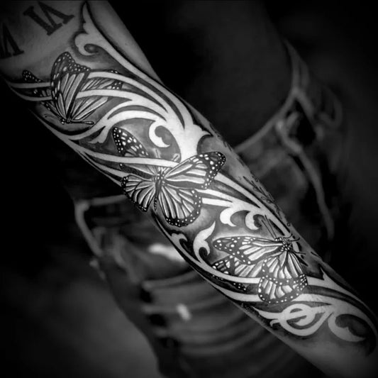 Big Negative Space Monarch Butterflies and Floral Vines Tattoo on Women Arm by @bigstevelewis