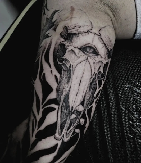 Big Negative Space Skull and Tribal Flames Tattoo on Men Arm by @karas.ink