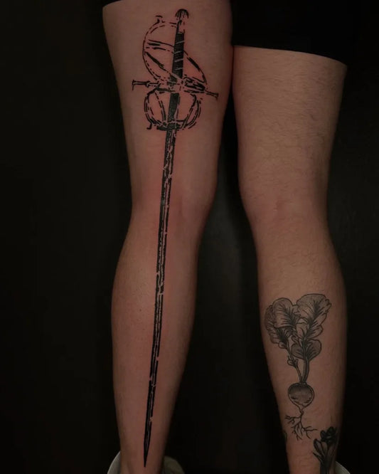 Big Negative Space Sword and Snake Tattoo on Women Thigh by @tapiotats