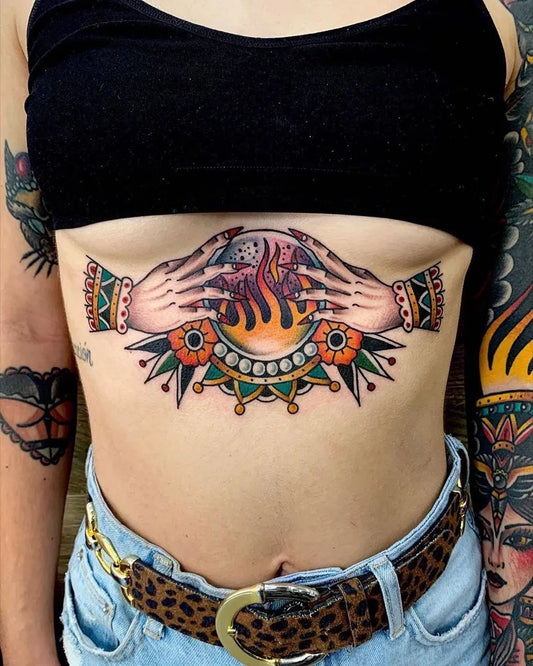 Big Neo Traditional Crystal Ball Fire Hands on Women Sternum Tattoo by @inkmindcrew