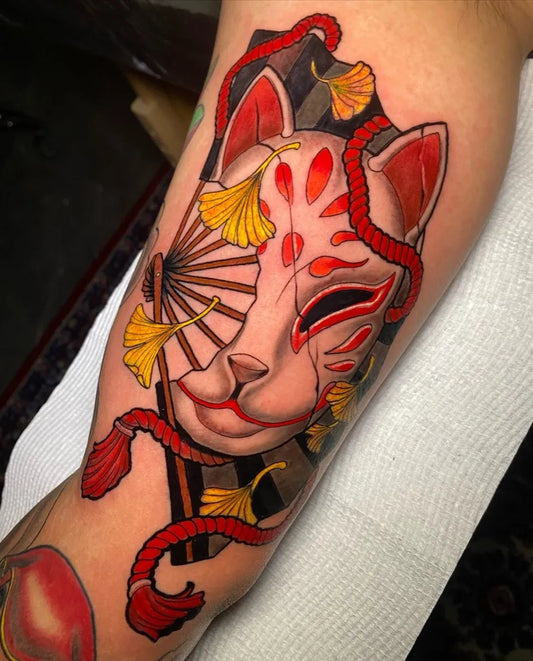 Big Neo Traditional Fox Mask with Ginkgo Leaves and Fan on Women Arm Tattoo by @radalism_tattoo