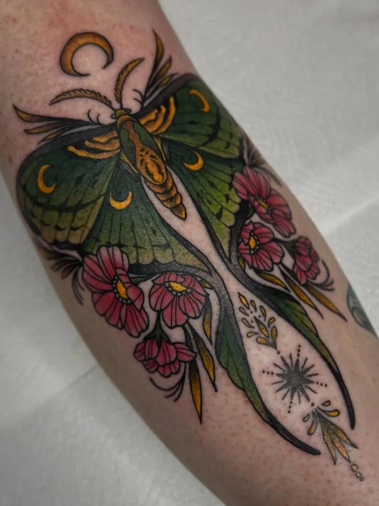 Big Neo Traditional Luna Moth and Flowers on Women Arm Tattoo by @evanbyrnetattoo
