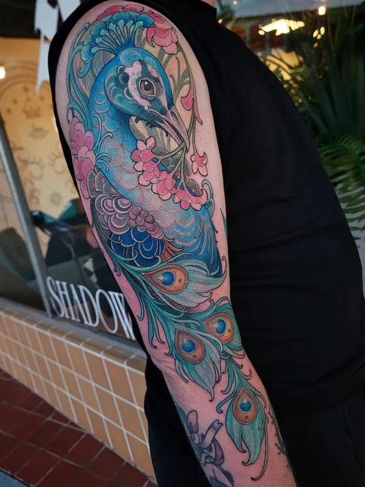 Big Neo Traditional Peacock and Cherry Blossoms Tattoo on Men Arm by @angela.emr_tattoos