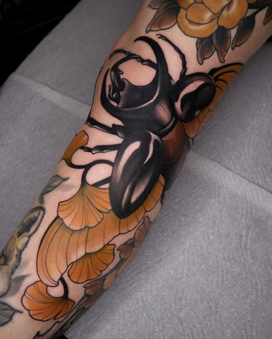 Big Neo Traditional Stag Beetle with Chrysanthemum on Women Knee Tattoo by @robin.kemper.tattoo
