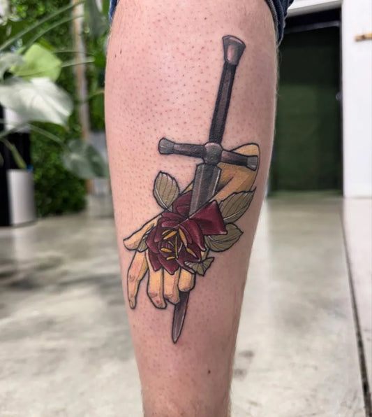 Big Neo Traditional Sword with Rose and Hand on Women Thigh Tattoo by @contradiction.studio