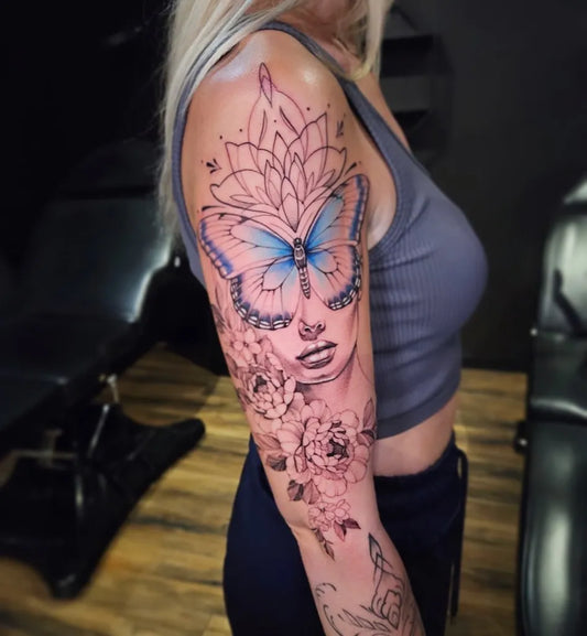 Big Neotraditional Butterfly Portrait and Flowers on Women Arm Tattoo by @kristal_ink_tattoo