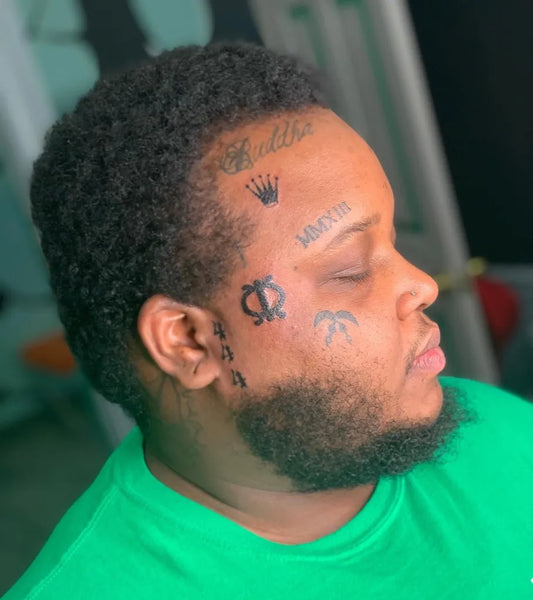 Big Neotraditional Crowns and Symbols on Men Face Tattoo by @coyotegrace_tattoos