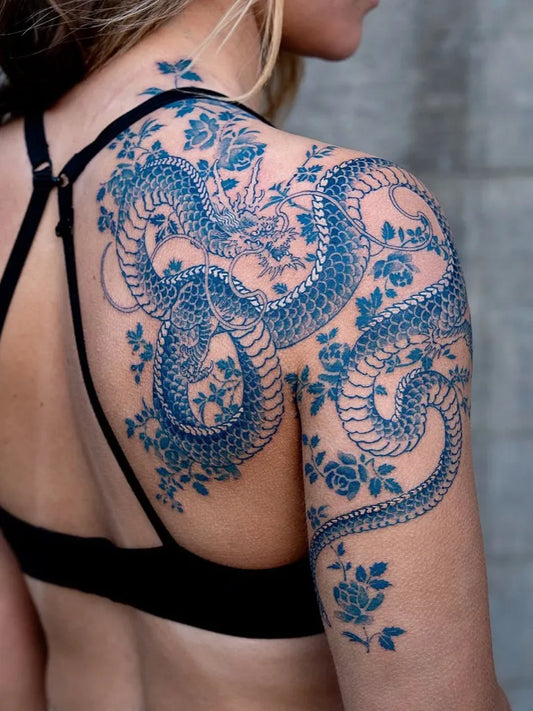 Big Neotraditional Dragon and Roses on Women Shoulder Tattoo by @tattoosfolder