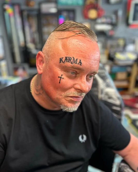 Big Neotraditional Karma Cross on Men Face Tattoo by @_tattoo.bay