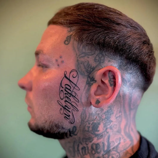 Big Neotraditional Name and Floral Patterns on Men Face Tattoo by @andyinit.tattoo