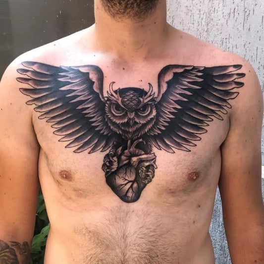 Big Neotraditional Owl with Heart on Men Chest Tattoo by @gegolli.tattoos_