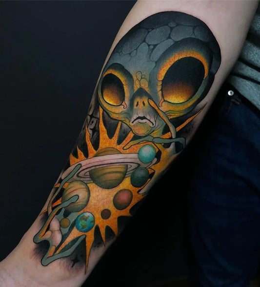 Big New School Alien with Planets Tattoo on Men Arm by @tattoosnob