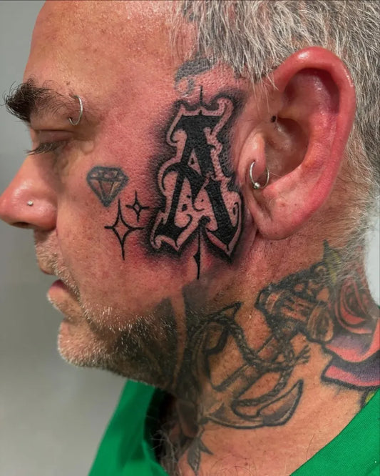 Big Old English Letter A with Diamonds on Men Face Tattoo by @rarebreed_tattoo
