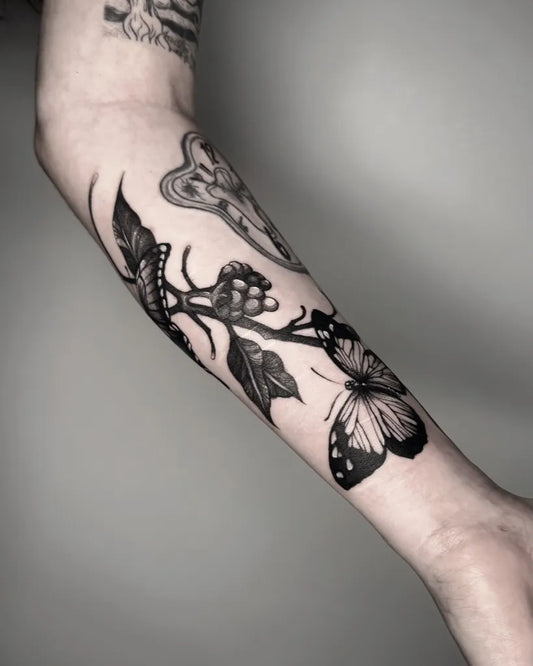 Big Patchwork Butterfly Vine Leaves on Women Arm Tattoo by @ghoulish.ink
