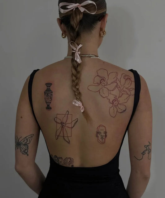 Big Patchwork Orchids Skull Butterfly on Women Back Tattoo by @domanska.ink