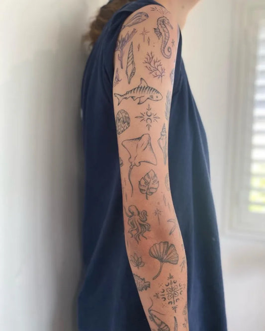 Big Patchwork Sea Life Shells Feathers on Women Arm Tattoo by @jaz_adele_ink