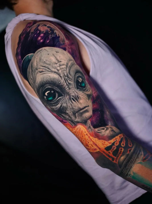 Big Realism Alien with Cosmic Background Tattoo on Men Arm by @fabiansoto_tattoo