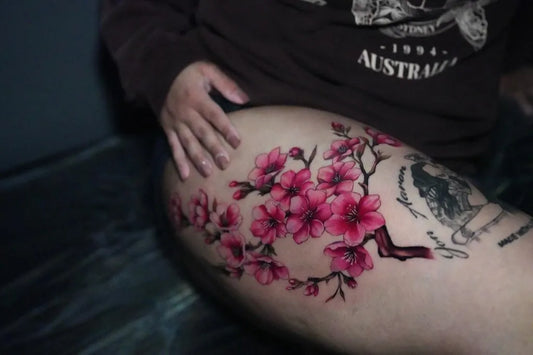 Big Realism Cherry Blossom Branches on Women Thigh Tattoo by @kotono_tattooer