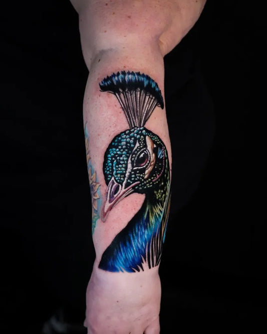 Big Realism Peacock Tattoo on Women Arm by @blackrabbitslc