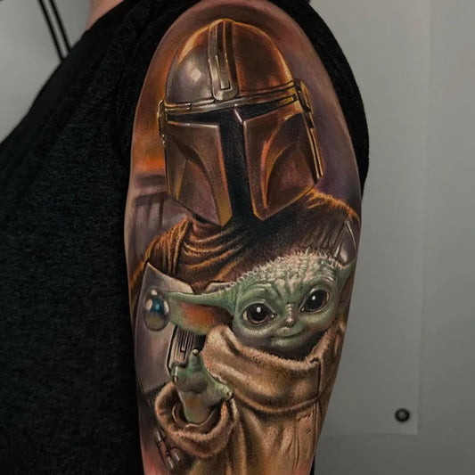Big Realism Star Wars Mandalorian and Baby Yoda Tattoo on Women Shoulder by @joshuaandersontattoo