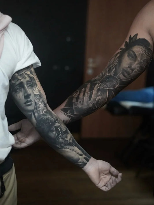 Matching Realism Woman's Face with Laurel and Hand Tattoo on couple arms by @gianluca_napolitano_tattoo