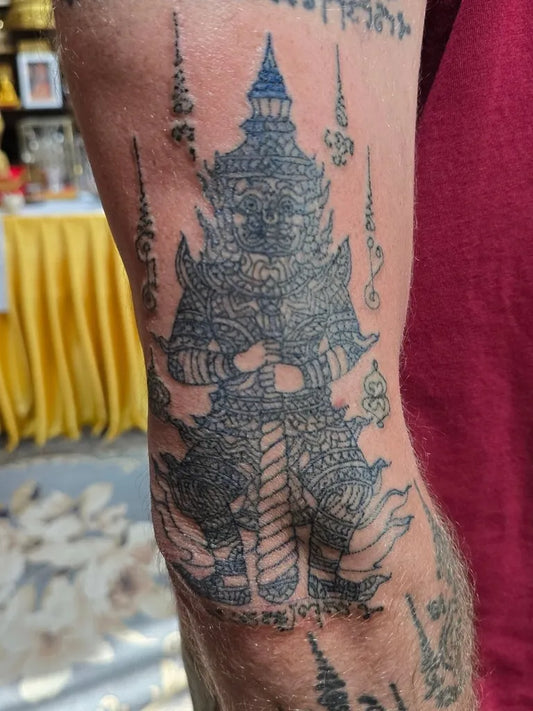 Big Sak Yant Guardian Figure with Sacred Script Tattoo on Men Thigh by @arjarn_wut_huahin