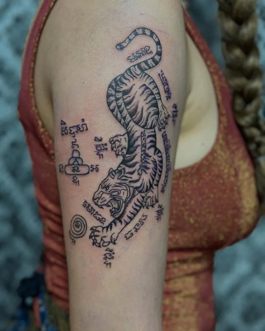 Big Sak Yant Tiger with Script Tattoo on Women Arm by @preservation_khmer_sakyant
