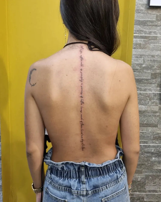 Big Script Crescent Moon on Women Spine Tattoo by @buccaneertattoo