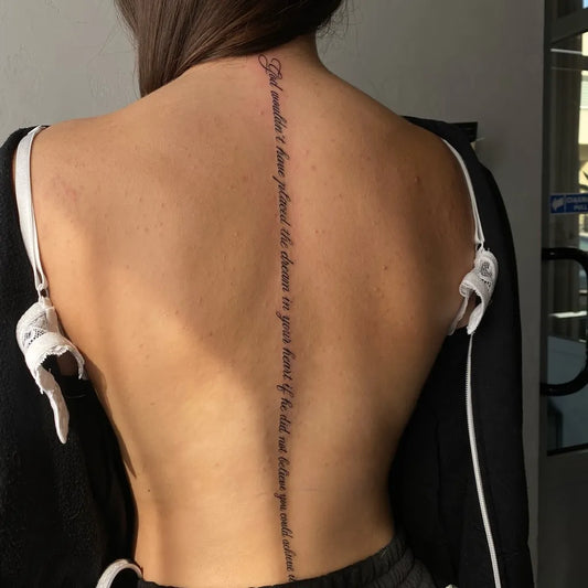 Big Script Quote on Women Back Tattoo by @mvrtatattoo