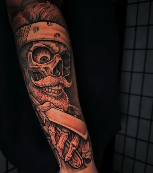 Big Skull Neo Traditional Skull with Bandana and Barber Razor on Men Arm Tattoo by @john_cameron_tattoos