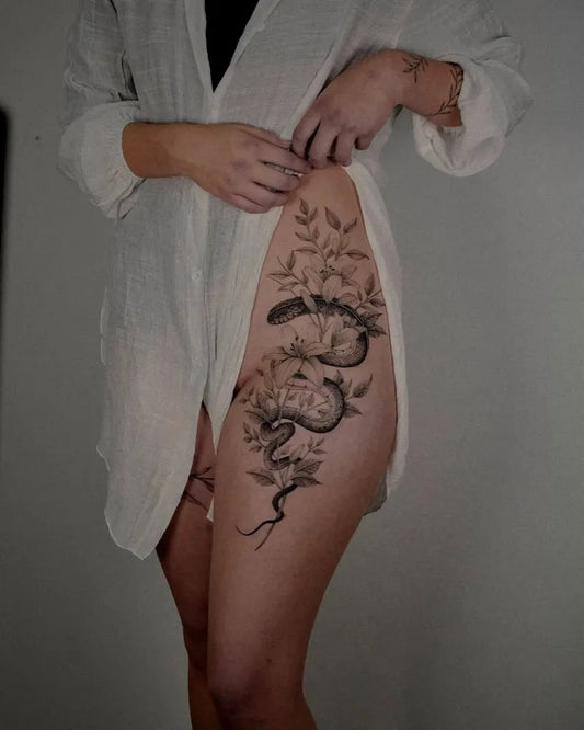 Big Snake and Flowers on Women Thigh Tattoo by @sinnersinc