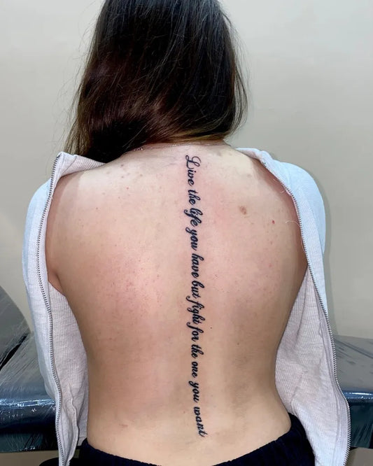 Big Text Words on Women Spine Tattoo by @kgtattoojo