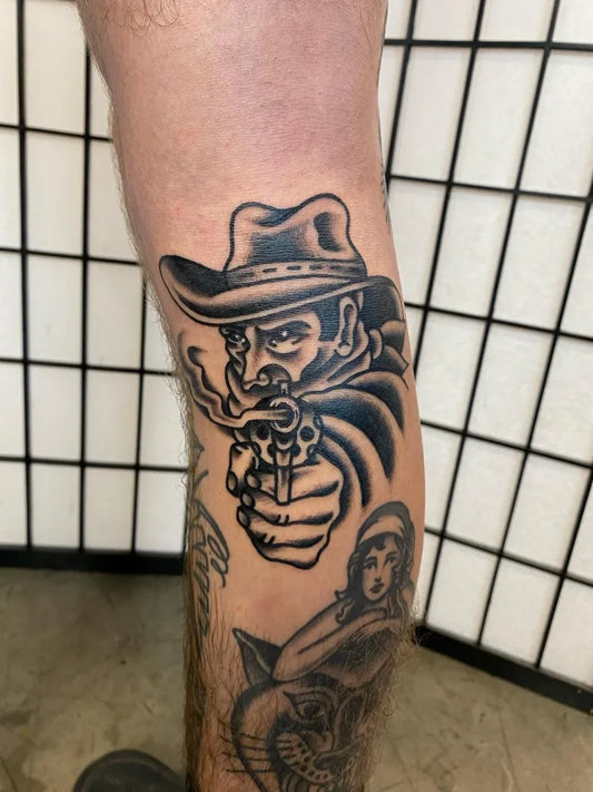 Big Traditional Cowboy with Gun and Woman Tattoo on Men Thigh by @kingsleytattoo