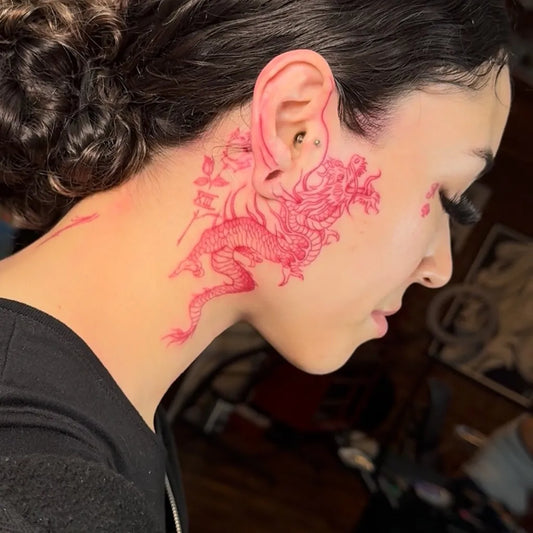 Big Traditional Dragon on Women Face Tattoo by @tattoo_la_leslie