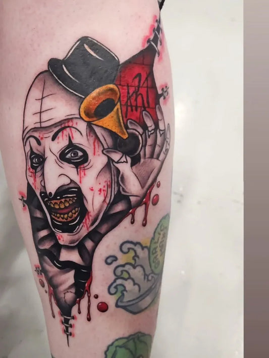 Big Traditional Horror Clown Tattoo on Women Thigh by @ciara.elizabeth.mullaniff