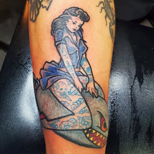 Big Traditional Pin Up Girl Riding Shark Tattoo on Women Arm by @stefantattooxiii