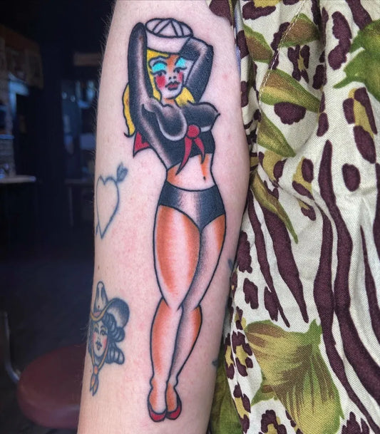 Big Traditional Pin Up Girl Tattoo on Women Arm by @tattoosbyfreddie