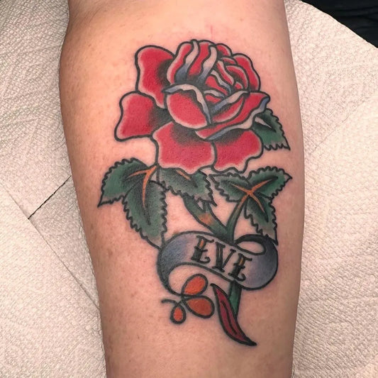 Big Traditional Rose with Eve Banner on Men Arm Tattoo by @selfcaretattooco