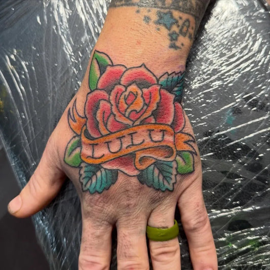 Big Traditional Rose with Lulu Banner on Men Hand Tattoo by @spencerecoco