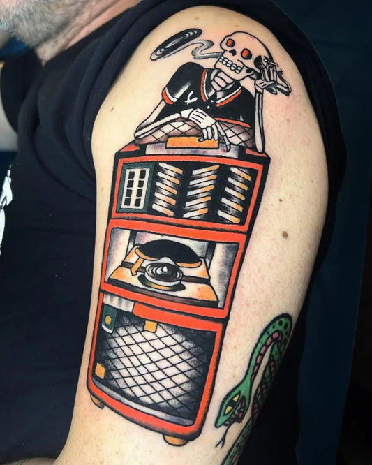 Big Traditional Skeleton Jukebox Snake Music Tattoo on Men Shoulder by @isasantanatattoo